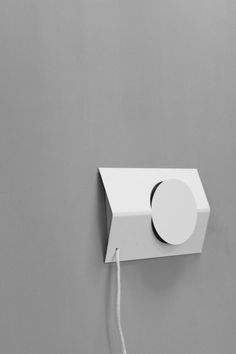 an electrical device is plugged into the wall with a cord attached to it, in black and white