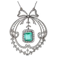 Platinum, white gold, Antique Edwardian diamond, and emerald pendant necklace. The edwardian era was called Belle époque (beautiful era) in France. The delicate center emerald weighs 3.29 carats and is an old emerald cut. A combination of Old European Cut and Single Cut diamonds surrounds the emerald. The attention to detail and intricate craftsmanship are showcased throughout the pendant in 18-karat white gold and platinum. The lace-like open metal design is what makes the Victorian Era so beau Emerald Pendant Necklace, The Edwardian Era, Emerald Necklace Pendant, Edwardian Jewelry, Emerald Pendant, Edwardian Era, Gorgeous Jewelry, Dream Jewelry, Belle Epoque