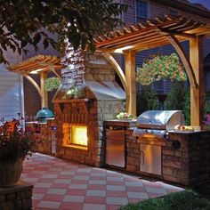 an outdoor bbq grill is lit up at night