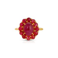 A center oval Cabochon Ruby in fiery hues of deep red and magenta enhanced by a setting of faceted Rubies in a stylish gold dress ring of modern cluster design. - Natural Rubies weight approx 6.50 Carats.- Set in 22 Karat gold overlay silver.- Size 7, resizable. Luxury Ruby Oval Cabochon Ring, Yellow Gold Cabochon Ruby Ring, Luxury Ruby Ring Oval Cabochon, Luxury Ruby Cluster Ring, Luxury Oval Ruby Birthstone Ring, Cabochon Ruby Ring For Anniversary, Formal Cluster Ruby Ring, Luxury Red Cluster Ring, Fine Jewelry Ruby Ring With Oval Cabochon