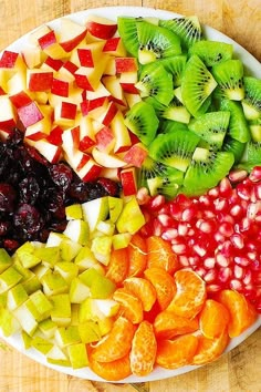 a platter filled with sliced fruit on top of a wooden table