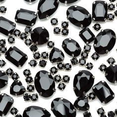 lots of black crystal stones on a white surface