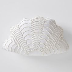 a white cloud shaped pillow sitting on top of a table