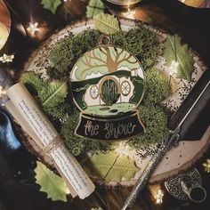 an image of a tree house ornament surrounded by leaves and other items on a table