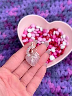 "DESCRIPTION: Wire-wrapped heart-shaped pendant with a rose quartz heart cabochon as the centerpiece and angel aura accent beads. Wires used are 16G, 22G & and 26G rose gold-plated silver (Artistic Wire brand. Pendant size approx. 1\" x 1.5\" and comes strung on an adjustable black cord (pictured)*. NOTE ON MATERIALS: **Please ensure that you do not have allergies to the listed metals. I do not accept returns/all sales are final." Wire Wrapped Jewelry For Valentine's Day Anniversary, Valentine's Day Wire Wrapped Jewelry For Anniversary, Heart-shaped Healing Jewelry For Mother's Day, Heart Beads Jewelry For Healing On Valentine's Day, Wire Wrapped Jewelry For Valentine's Day Gift, Valentine's Day Wire Wrapped Jewelry Gift, Valentine's Day Gift Jewelry Wire Wrapped, Aura Heart, Heart Rose Quartz