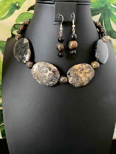 You will receive an unbelievably beautiful, black fossil coral, free-form, focal beaded necklace with earrings. These fantastic focal beads are strung with black fossil coral beads. No joke! This necklace is gorgeous Fossil coral is formed when, over millions of years, agate deposits fossilize the coral's skeletons.  Amazing, right?  I've tried to zoom in on each of the focals to show the amazing fossil markings.   This stunning, eye-catcher makes quite a statement! I use a toggle clasp making i Costume Jewelry With Round Beads And Stones, Black Beaded Jewelry With Oval Beads, Black Beaded Agate Jewelry, Handmade Black Oval Beads Jewelry, Bohemian Onyx Round Bead Jewelry, Handmade Black Jewelry With Oval Beads, Black Oval Gemstone Beads Jewelry, Black Jewelry With Faceted Oval Beads, Black Jewelry With Oval Faceted Beads