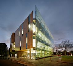 a large building with many windows and lights on it's sides at night time