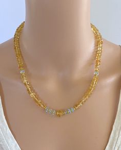 "A sparkly bit of sunshine and bright blue sky! This necklace of 7mm faceted Citrine rondelles are accented with faceted Blue Topaz rondelles.  A faceted barrel of Citrine provides the focal point. This necklace is 18\" in length and has a 2\" gold-filled extender chain so you can wear it short or long.  It looks great on its own or worn in layers. It features gold-filled beads and findings. NM Jewelry Design offers one-of-a-kind and limited edition jewelry. My creations are feminine, sophisticated and inspired by the cultures that traded along the ancient Silk Road. I am a Certified Gemologist and Accredited Jewelry Professional.   Please contact me for more information about the other necklaces shown in this listing." Formal Yellow Citrine Necklace, Elegant Beaded Citrine Necklaces, Elegant Yellow Citrine Necklace, Yellow Citrine Pendant Necklaces, Yellow Citrine Pendant Necklace, Briolette Necklace, Carnelian Necklace, Blue Topaz Necklace, Citrine Earrings