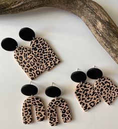 three pairs of leopard print and black acrylic earrings