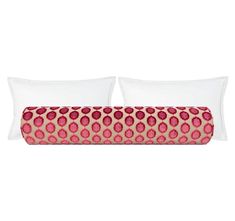 two white pillows with pink and red circles on the pillowcase, one is made out of