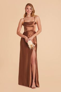 a woman in a brown bridesmaid dress posing for the camera with her hand on her hip