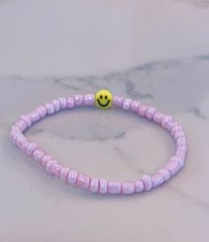 This bracelet is a great accessory to pair with anything! It could be a gift or even for yourself! The string is stretchy but not adjustable. :) Trendy Everyday Bracelet With Smiley Face, Trendy Everyday Bracelets With Smiley Face, Trendy Everyday Smiley Face Bracelet, Everyday Beaded Bracelets With Smiley Face, Cute Smiley Face Bracelets For Friendship, Cute Adjustable Beaded Bracelets For Everyday, Casual Adjustable Smiley Face Friendship Bracelets, Casual Smiley Face Friendship Bracelets, Casual Adjustable Smiley Face Bracelets