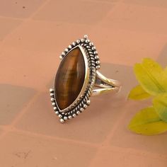 Tigers Eye Ring, Chunky Vintage Statement Ring, Natural Gemstone Ring, Womens Jewelry, Gift For Her * Material: High Quality Solid 925 Sterling Silver * Finish: Oxodised Silver Tiger Eye is a type of chatoyant gemstone that is prized for its unique, iridescent sheen. It's a type of quartz that has been subjected to high pressure and temperature, which causes the formation of fibers that create a shimmering, layered effect. Color: Tiger Eye typically has a golden, yellow-brown color with a metall Sterling Silver Ring With Gemstone Accents, Heirloom Sterling Silver Rings With Stone Setting, Anniversary Rings With Natural Stones, Sterling Silver Rings With Gemstone Accents, Unique Sterling Silver Ring With Gemstone Accents, Unique Sterling Silver Rings With Gemstone Accents, Sterling Silver Brown Rings With Polished Finish, Sterling Silver Rings With Brown Polished Finish, Brown Sterling Silver Rings With Polished Finish