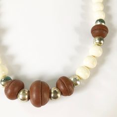 90s beaded necklace Brown leather, white and gold beads on a double brown string. String ties at the back of the neck The necklace is 30 inches long Some of the gold beads are tarnished, hence the low price. Otherwise the necklace is in good condition. Retro Adjustable Brown Jewelry, Retro Brown Adjustable Jewelry, Adjustable Brown Vintage Necklace, Brown Large Beads Necklace For Festival, Vintage Brown Adjustable Necklace, Retro Brown Beaded Jewelry, Everyday Brown Wooden Beaded Necklaces, Adjustable Brown Necklace With Large Beads, Adjustable Beaded Brown Choker