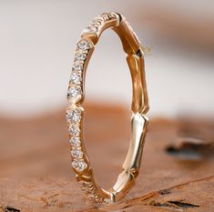 a gold wedding band with diamonds on it