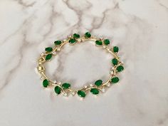 This emerald coloured bracelet has been created with AAA grade cubic zirconia crystals , this piece is fully adjustable so will fit most wrists.     An Ideal gift for most occasions but would especially suit the Bride, Bridesmaids, Mother of the Bride or even wedding guests !  All my bridal accessories are made to the very highest standard using the finest quality materials whilst paying care and attention to detail. Materials  . Sparkling finest AAA grade cubic zirconia crystals  . Emerald coloured cubic zirconia crystals  . Measures 16.5cm but can be extended to 20cm with an extender which is     included . Ships worldwide from West Wales in the U.K.  Cubic zirconia is similar to a diamond with its brilliance and crystal clarity, but it is a man-made material that is, hard, and flawless Emerald Green Jewelry, Green Jewellery, Bracelet Emerald, Emerald Bracelet, Bracelet Wedding, Green Jewelry, Wedding Jewelry Bracelets, Bridesmaid Bracelet, Gold Crystal