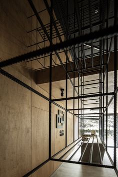 the interior of a building with metal bars on the walls and flooring in front of it