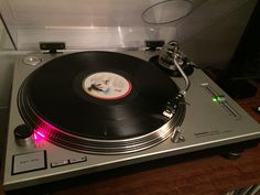 an old record player sitting on top of a table