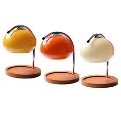 three different colored lamps sitting on top of each other