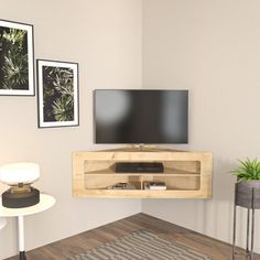 a flat screen tv mounted to the side of a wooden entertainment center in a living room