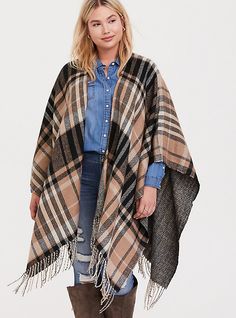 Soft and oversize, this ruana is comparable to a blanket with an oversized plaid pattern on one side and a herringbone pattern on the other side to guarantee it will match your fall outfits. Open front. Wrap sleeves lets you style it a variety of ways. Fringe trim. CONTENT + CARE: Acrylic. Wash cold; dry flat. Imported plus size kimono. SIZE + FIT: Model is 5’10”. This item is One Size and measures 34. 5” from shoulder. The best plus size women's caramel plaid fringe ruana capes ponchos & ru Skirt Hacks, Winter Family Photography, Diy Clothes Hacks, Turtleneck Poncho, Brunch Outfits, Plus Size Kimono, Plaid Poncho, Clothes Life Hacks, Women Scarves