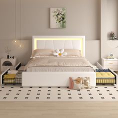 a white bed sitting on top of a wooden floor next to a night stand and lamp