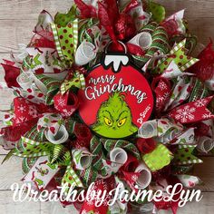 the grinch christmas wreath with red and green bows