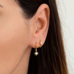 "Delicate huggie hoop earrings with a small dainty star charm. Understated and elegant, these dainty hoops will mix and match effortlessly with other earrings and are perfect for everyday wear. ∙ Sold individually (1 earring) or by pair (2 earrings) * D E T A I L S * ∙ Material: .925 Sterling Silver or 18K Gold Plated over .925 Sterling Silver ∙ Stone: White Zirconia ∙ Dimensions: Inner diameter: 9mm // Star charm: 8mm ∙ Hypoallergenic & nickel-free * P A C K A G I N G * ∙ All jewelry is sen Star Huggie Earrings, Gold Aesthetic Earrings, Sterling Silver Celestial Hoop Earrings With Star Charm, Celestial Sterling Silver Hoop Earrings With Star Charm, Huggie Earrings With Star Charm, Star-shaped Tarnish Resistant Hoop Earrings For Everyday, Celestial Huggie Earrings With Star Charm Dangle, Celestial Dangle Huggie Earrings With Star Charm, Sterling Silver Star Huggie Earrings Minimalist Style