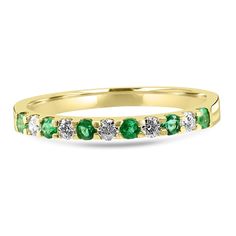 a yellow gold band with green and white stones