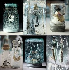 there are many glass jars that have snow in them, and some trees inside one