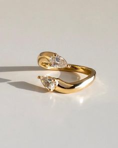 two yellow gold rings with diamonds on them