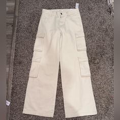 Brand New Cream Colored Cargo Pants With Pockets Wide-leg Cargo Jeans For Spring, Straight Cargo Jeans With Hip Pockets For Spring, White Straight Leg Pants With Multiple Pockets, High Rise White Cargo Bottoms, Beige Wide Leg Cargo Pants With Five Pockets, White High Rise Cargo Bottoms, White High-rise Cargo Bottoms, High Rise White Cargo Style Bottoms, White High Rise Cargo Style Bottoms