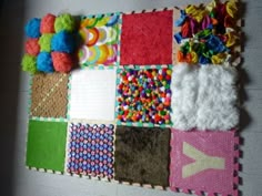 there is a patchwork wall hanging made out of different colors and patterns on the wall