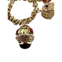 This beautiful mid century modern Etruscan revival bracelet is set in 18K yellow gold.   This heavy bracelet is set with assorted semi precious stones. - light scratching, chips to some stones as shown  2 of the charms open as shown.   8" in length from end to end, approx. 7" wrist size  106.8 g / 68.6 dwt  Stamped 750  Charms up to 35mm in length and 24mm wide  Bracelet is approx. 11mm wide  Very good preowned condition. Just polished by our jeweler.  Will be shipped express mail with insurance in a gift box. Antique Metal Bracelet With Charms, Yellow Gold Metal Bracelet With Vintage Charm, Antique Charm Bracelet Jewelry, Antique Charms Bracelet Jewelry, Heirloom Multi-stone Yellow Gold Jewelry, Heirloom Charms Jewelry For Collectors, Engraved Heirloom Metal Jewelry, Antique Yellow Gold Bracelets With Vintage Charm, Ornate Pendant Jewelry With Charms