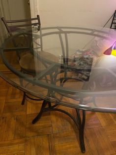 a glass table with chairs around it