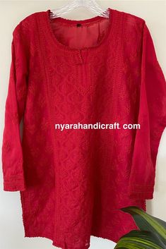 "Soft cotton Chikankari hand embroidered blouse. Matching liner Included. Length: 30 inches Color: Red \"Embroidery designs vary \"" Luxury Chikankari Embroidered Tops For Festive Season, Red Kurta With Floral Embroidery For Transitional Season, Red Floral Embroidered Kurta For Transitional Season, Red Floral Embroidery Kurta For Transitional Season, Embroidered Straight Kurta Top In Chanderi, Embroidered Chanderi Straight Kurta Top, Festive Chikankari Embroidered Top, Red Straight Kurta Top For Festive Occasions, Traditional Red Floral Embroidered Kurta