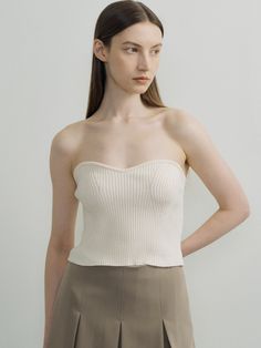 Editor's NotesThis is a knit bustier top in which the knitted fabric of the bust line and the front line are knitted in a three-dimensional sense. It is a coordinating item that looks fashionable when worn over a shirt or ribbon T-shirt.- Slim fit makes the waist look slim- Unique styling items for fall and winter- Available in 3 colors: Ivory, Blue, Gray*The color of the product may differ from the actual color depending on the device and resolution used.Measurements(in.)ONE SIZE (XS-M)- Length (Based on chest line): 11.02 in.- Length (Based on back center): 9.06 in.- Chest: 11.22 in.- Waist: 11.02 in.- Hem: 11.02 in.- Bust line rib height: 0.39 in.*Model size: Height 5'74, Bust 32.5, Waist 25, Hips 37*The size of the product may have an error of 0.39 to 1.18 inch depending on the measure Seamless Cropped Beige Top, Chic Bandeau Top With Built-in Bra, Elegant Fitted Beige Knit Top, Chic Fitted Knit Tank Top, Fitted Beige Tops With Built-in Bra, Chic Seamless Bandeau Top, Fitted Textured Knit Beige Tops, Beige Seamless Crop Top, Fitted Chic Knit Top