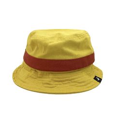 Yellow linen bucket hat with red stripe. Casual Bucket Hat For Vacation, Casual Flat Brim Bucket Hat For Summer, Adjustable Cotton Bucket Hat With Uv Protection, Summer Bucket Hat With Adjustable Fit For Vacation, Adjustable Cotton Summer Hat, Casual Bucket Hat With Flat Brim For Beach, Yellow Fedora With Flat Brim For Summer, Adjustable Summer Bucket Hat For Vacation, Trendy Lightweight Adjustable Bucket Hat