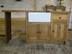 a kitchen island made out of wood with a white counter top and two drawers on each side