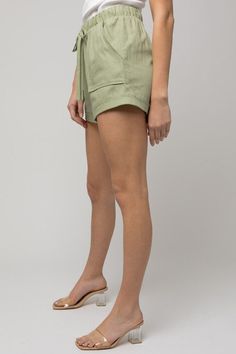 MODEL IS WEARING A SIZE SMALL MODEL SPECS HEIGHT: 5'10" BUST: 33B WAIST: 23.5" HIPS: 35" Roll Up Design, Cream Fabric, Lightweight Shorts, Linen Shorts, Moss Green, Everyday Wardrobe, Small Waist, Sheer Fabrics, Shorts With Pockets