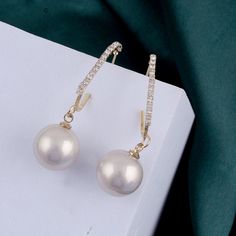 Expertly crafted with genuine pearls, these earrings radiate elegance and sophistication. Each earring boasts a unique, lustrous pearl, symbolizing wisdom and purity. The perfect accessory for any formal occasion or to add a touch of refinement to your everyday look. Pearl White Pearl Earrings, Pearl Earrings For Evening, Elegant Pearl White Earrings With Pearl Charm, Elegant Pearl White Pearl Earrings For Party, Classic Pearl Earrings For Parties, Formal Pearl Hoop Earrings With Pearl Charm, Elegant Pearl Pendant Earrings, Elegant Pearl Earrings With Pearl Pendant, Elegant Pearl Earrings With Pendant