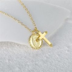 This stylish Gold Cross Charm Necklace features a beautiful Cross pendant with an intricately detailed Virgin Mary charm. Meticulously crafted with a pressed sheet of silver making it lightweight, this necklace is perfect for any special occasion. DETAILS & SIZE Finish: 18K gold plate Material: .925 sterling silver Measurements: Chain: 16" + 2" extension Lobster claw clasp Shop Necklaces for more options to layer this with! Gold Symbolic Initial Pendant Necklace, Symbolic Gold Initial Pendant Necklace, Silver Engraved Gold Plated Jewelry, Sterling Silver Necklaces With Cross Pendant Charms, Silver Gold-plated Oval Pendant Jewelry, Silver Cross Necklace With Coin Pendant, Sterling Silver Cross Pendant Necklace With Charms, Gold Sterling Silver Engraved Charm Necklaces, Gold Plated Engraved Medallion Pendant Necklace