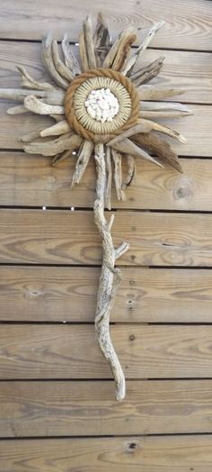 a clock made out of driftwood on a wooden wall