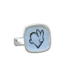 This adorable Rabbit ring will bring you joy every time you wear it. I carved the sterling silver ring setting from a block of wax, then cast that wax ring into metal and molded it so I can make multiples. This ring setting then gets a layer of vitreous enamel (fine glass) and fired at 1400 in a kiln four separate times to build strength and color saturation . Finally I take an illustration from my sketchbook, turn it into an enamel  screen print, and fire that on the top for a durable, waterpro White Enamel Sterling Silver Ring As A Gift, White Sterling Silver Enamel Ring As Gift, Adjustable White Sterling Silver Signet Ring, Adjustable Enamel Sterling Silver Ring As Gift, White Gold Sterling Silver Enamel Ring For Gift, White Gold Sterling Silver Enamel Ring As Gift, Adjustable Sterling Silver Enamel Ring Gift, Sterling Silver Enamel Ring Gift, Handmade White Sterling Silver Signet Ring