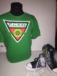 Up for grabs in this listing is the exclusive Converse DC Comics "Green Arrow" in a Men's size 12 with matching shirt size Extra Large. Items are brand new and kept in a smoke free, pet free environment. Items are shipped via USPS priority mail. Please view all pics and bid with confidence. Green Fan Merchandise T-shirt With Logo, Green T-shirt With Logo Print For Fans, Green Logo Print T-shirt For Fan Merchandise, Casual Cotton Tops For Fan Events, Green Tops With Logo Print For Fans, Green Tops With Logo Print For Fan Merchandise, Green Cotton Shirt For Streetwear, Casual Tops With Graphic Print For Comic-con, Casual Graphic Print Tops For Comic-con