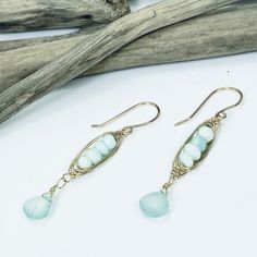 Our Seascape Stack earrings are the perfect beachy accessory for adding a pop of color to your wardrobe. Faceted Peruvian Opal and Chalcedony gemstones boast gorgeous sea green colors and are accented with 14k gold filled wire wrapping. Length: 2" Peruvian Opal and Chalcedony 14k gold filled Beach Wire Wrapped Drop Earrings, Green Bohemian 14k Gold Filled Earrings, Bohemian 14k Gold Filled Jewelry For Beach, Turquoise Wire Wrapped Earrings For Beach, Handmade 14k Gold Filled Jewelry For The Beach, Bohemian Turquoise 14k Gold Filled Earrings, Bohemian Turquoise 14k Gold-filled Earrings, Turquoise 14k Gold Filled Bohemian Earrings, Turquoise Gold Bohemian Earrings