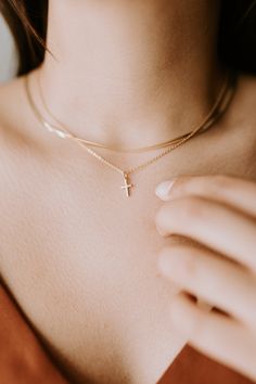 Where everyday elegance meets personal significance, our Cross Necklace is a beautifully delicate statement of faith. Its refined design adds a touch of grace to any outfit while holding deep, personal meaning.∙ D E T A I L S ∙ - 18K Gold Filled - 16 ,18 or 20 inches in length - Hypoallergenic (lead + nickel free) ∙ G O L D ∙ F I L L E D ∙ Gold-filled components contain 100+ times more real gold than gold-plated components and are both durable and tarnish resistant. It is more affordable and accessible than solid gold but higher quality than gold plated. Cross Necklace Gold, Necklaces Simple, Dainty Cross Necklace, Cross Necklaces, Unique Pendant Necklace, Everyday Elegance, Gold Filled Ring, D F, Jewelry Essentials