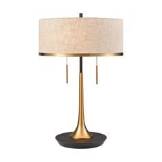 a lamp that is sitting on top of a wooden base with a beige shade over it