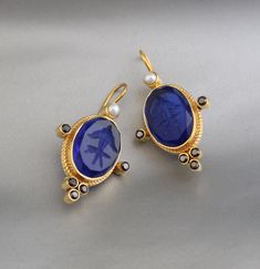 Description Gemstone} - Indigo Blue Glass Metal} - BRASS Gemstone Size - 13X18 mm Earring Height Including Hoop - 4.5 cm Earring Width - 2.5 cm Finish - Smooth and high polished with brilliant shine. {Note} -The earrings are made to order, production day is about 3-5 working days. The one you receive may be slight different from the one in the picture due to handmade nature, but it will be almost same as in the above picture.These pieces are handcrafted from start to finish and have an imperfect handmade look.These earrings are the perfect addition to your collection. Our rings are meant to be classic enough for everyday wear or to give as a bridesmaid gift. Natural stones may vary slightly in shape, size and color.Handmade Item You will receive the same piece as in the picture or identica Blue Gemstone Crystal Earrings, Blue Clip-on Earrings For Gift, Blue Clip-on Earrings For A Gift, Blue Pendant Earrings For Wedding, Blue Round Clip-on Jewelry, Blue Gemstone Pendant Earrings, Blue Oval Earrings For Wedding, Blue Pendant Earrings For Gift, Blue Oval Clip-on Earrings