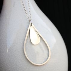 raindrop necklace rainy day minimalist modern jewelry Modern Long Drop Jewelry For Everyday, Modern Long Drop Everyday Jewelry, Elegant Dangle Jewelry For Everyday Use, Elegant Teardrop Drop Necklace For Layering, Modern Teardrop Drop Earrings For Everyday, Modern Dangle Drop Necklace As Gift, Modern Dangle Drop Necklace For Gifts, Everyday Sterling Silver Teardrop Pendant Necklace, Minimalist Silver Teardrop Pendant Earrings